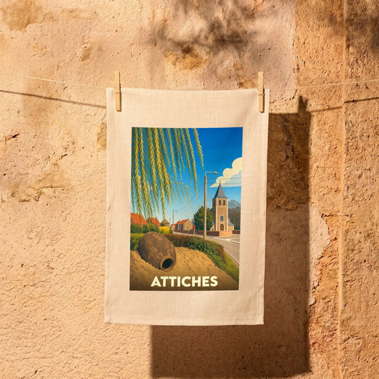 Torchon souvenir de la ville d'Attiches orné d'une illustration stylisée représentant son église et son paysage.