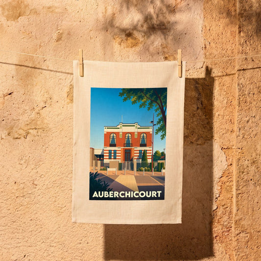 Torchon souvenir de la ville d'Auberchicourt illustré d'une vue stylisée de l'Hôtel de ville.