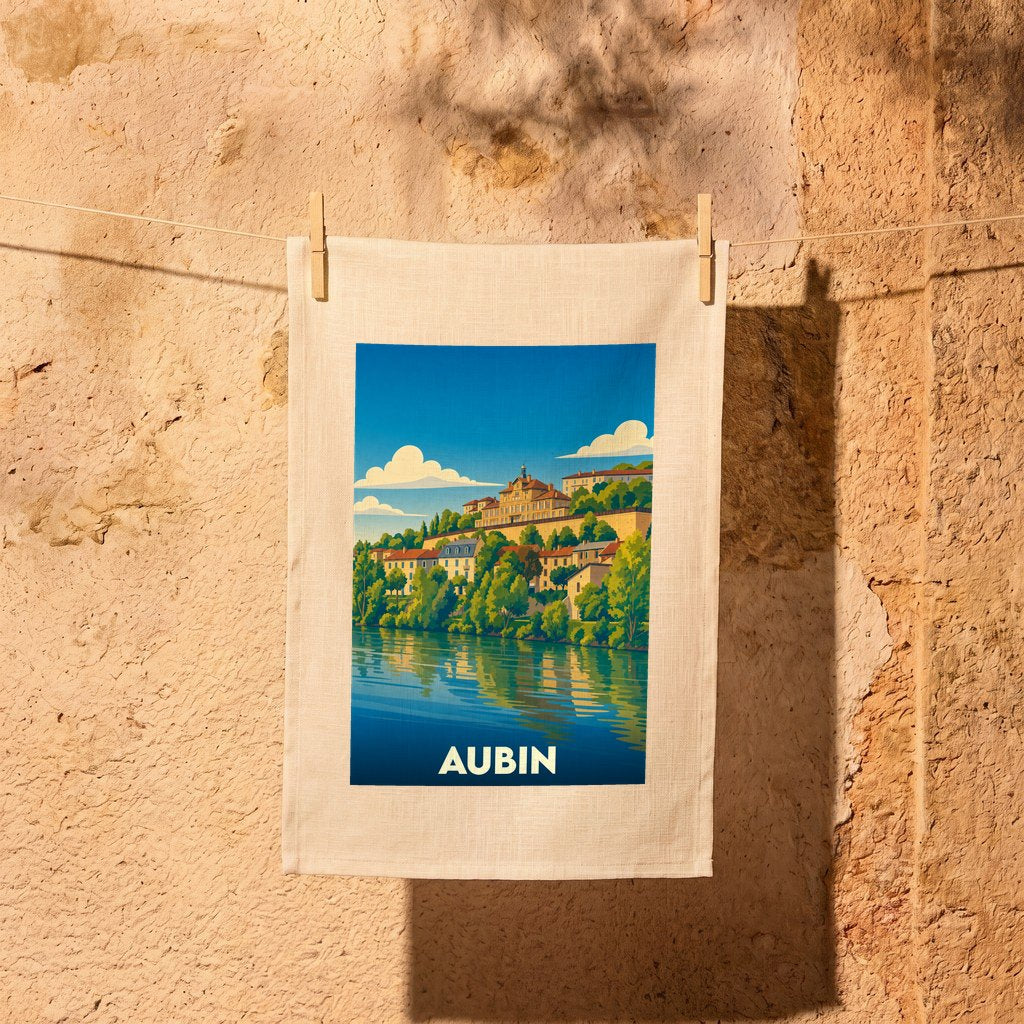 Torchon souvenir de la ville d'Aubin avec une illustration stylisée d'un paysage fluvial.