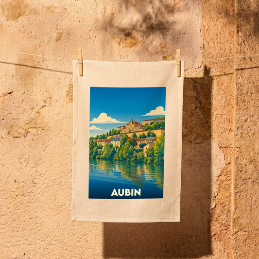 Torchon souvenir de la ville d'Aubin avec une illustration stylisée d'un paysage fluvial.