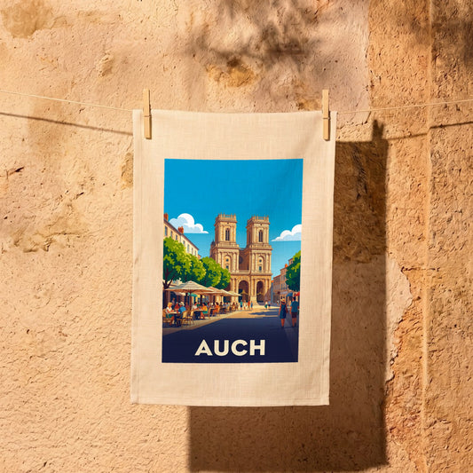 Torchon souvenir de la ville de Auch avec une illustration stylisée de la cathédrale et de terrasses de café.