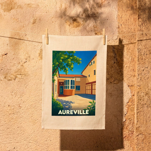 Torchon souvenir de la ville d'Aureville avec une illustration stylisée d'une cour ensoleillée.