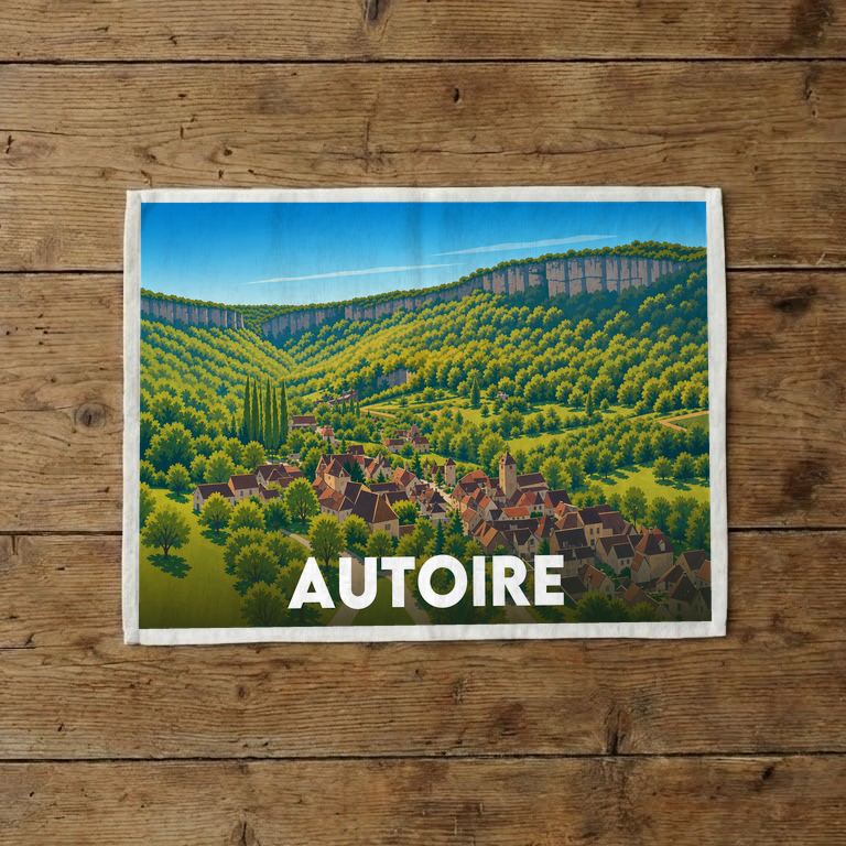 Torchon souvenir de la ville d'Autoire avec une illustration stylisée représentant le village au cœur d'une vallée verdoyante.