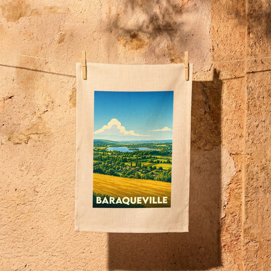 Torchon souvenir de la ville de Baraqueville orné d'une illustration paysagère stylisée.