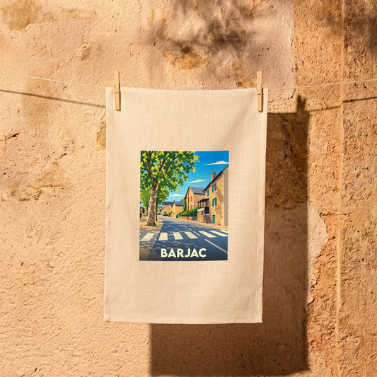 Torchon souvenir de la ville de Barjac avec une illustration stylisée d'une rue ensoleillée.