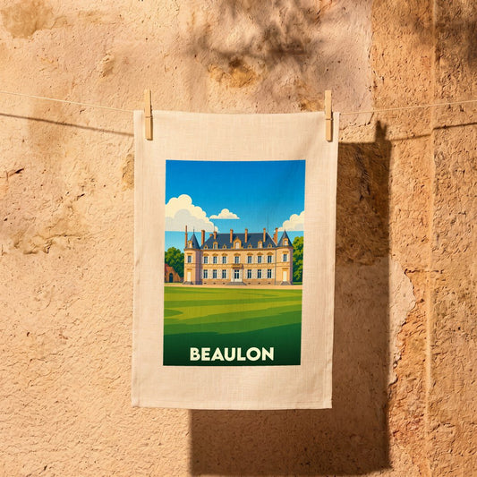 Torchon souvenir de la ville de Beaulon illustré d'un château stylisé suspendu par des pinces à linge sur un mur en pierre.