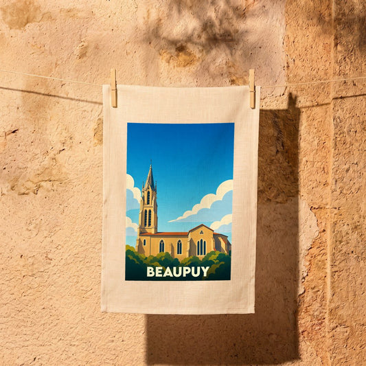 Torchon souvenir de la ville de Beaupuy avec une illustration stylisée de son église sous un ciel bleu.