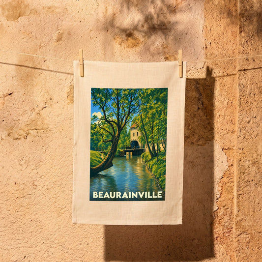 Torchon souvenir de la ville de Beaurainville avec une illustration stylisée d'un moulin au bord de l'eau.