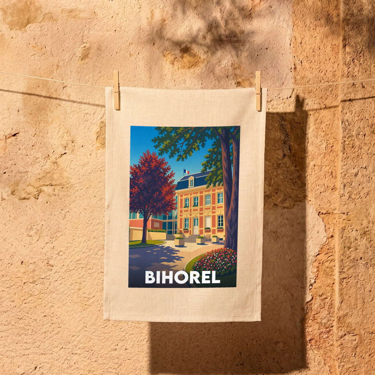 Torchon souvenir de la ville de Bihorel avec une illustration stylisée de son architecture et d'arbres colorés.