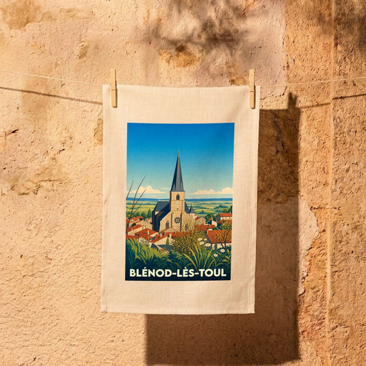 Torchon souvenir de la ville de Blénod-lès-Toul avec une illustration stylisée de son église et de ses toits.
