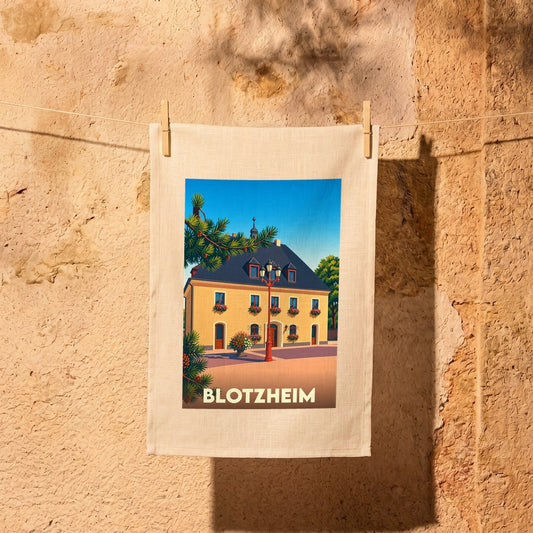 Torchon souvenir de la ville de Blotzheim avec une illustration stylisée.