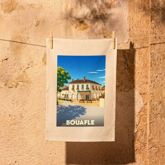 Torchon souvenir de la ville de Bouafle avec une illustration stylisée d'une bâtisse ensoleillée.