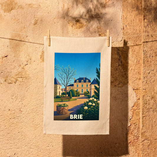Torchon souvenir de la ville de Brie avec une illustration stylisée d'un château et de ses jardins.