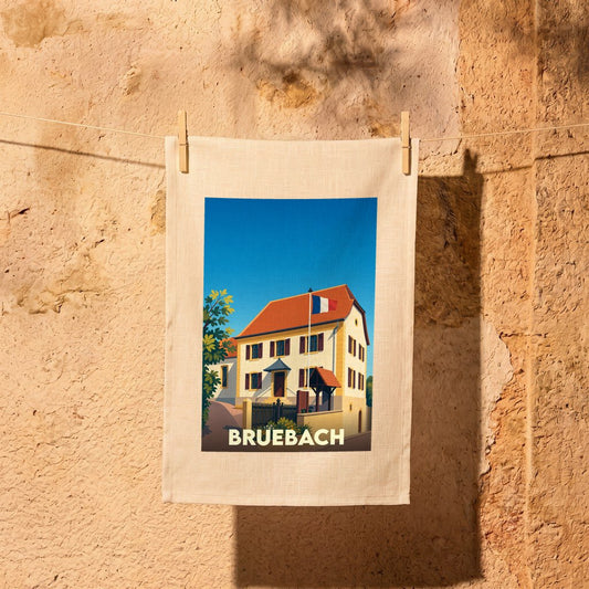 Torchon souvenir de la ville de Bruebach orné d'une illustration stylisée de sa mairie.