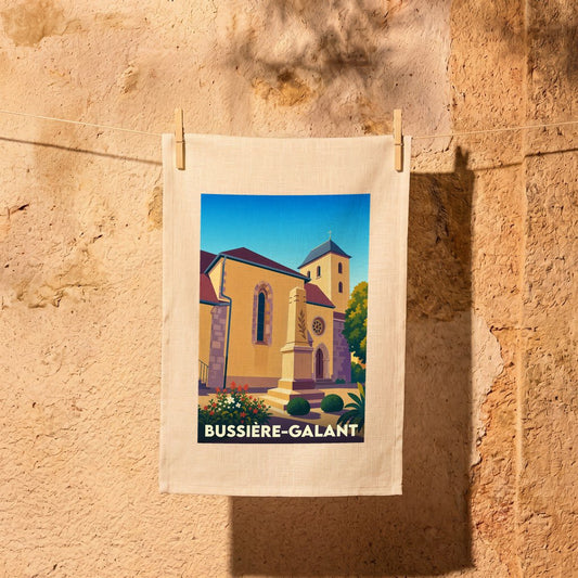 Torchon souvenir de la ville de Bussière-Galant avec une illustration stylisée de son église et de son monument.