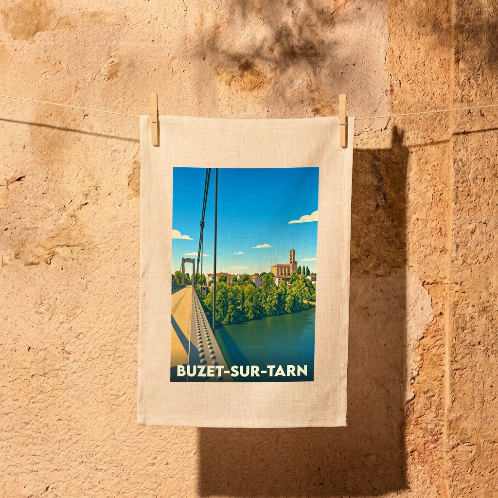 Torchon souvenir de la ville de Buzet-sur-Tarn avec une illustration stylisée d'un pont suspendu au-dessus d'une rivière.