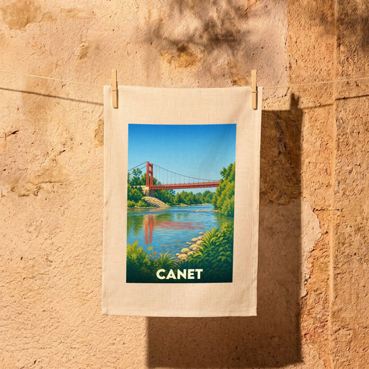 Torchon souvenir de la ville de Canet avec une illustration stylisée d'un pont suspendu enjambant une rivière.