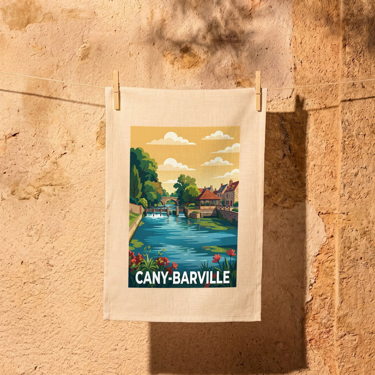 Torchon souvenir de la ville de Cany-Barville avec une illustration stylisée d'un paysage au bord de l'eau.