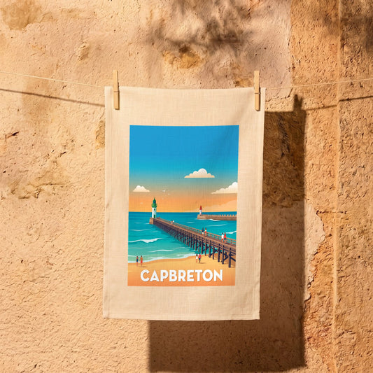 Torchon souvenir de la ville de Capbreton avec une illustration stylisée de son estacade au bord de l'océan.