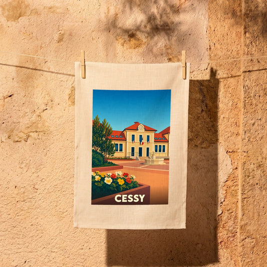 Torchon souvenir de la ville de Cessy avec une illustration stylisée d'un bâtiment officiel sous un ciel bleu.