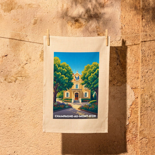 Torchon souvenir de la ville de Champagne-au-Mont-d'Or avec une illustration stylisée de sa mairie fleurie.
