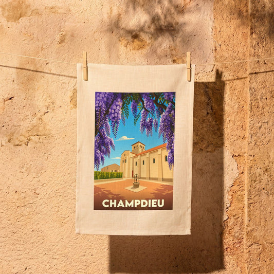 Torchon souvenir de la ville de Champdieu illustré d'une église et de fleurs de glycine.