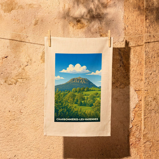 Torchon souvenir de la ville de Charbonnières-les-Varennes avec une illustration stylisée d'un paysage montagneux.