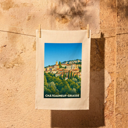 Torchon souvenir de la ville de Châteauneuf-Grasse avec une illustration stylisée d'un village perché.