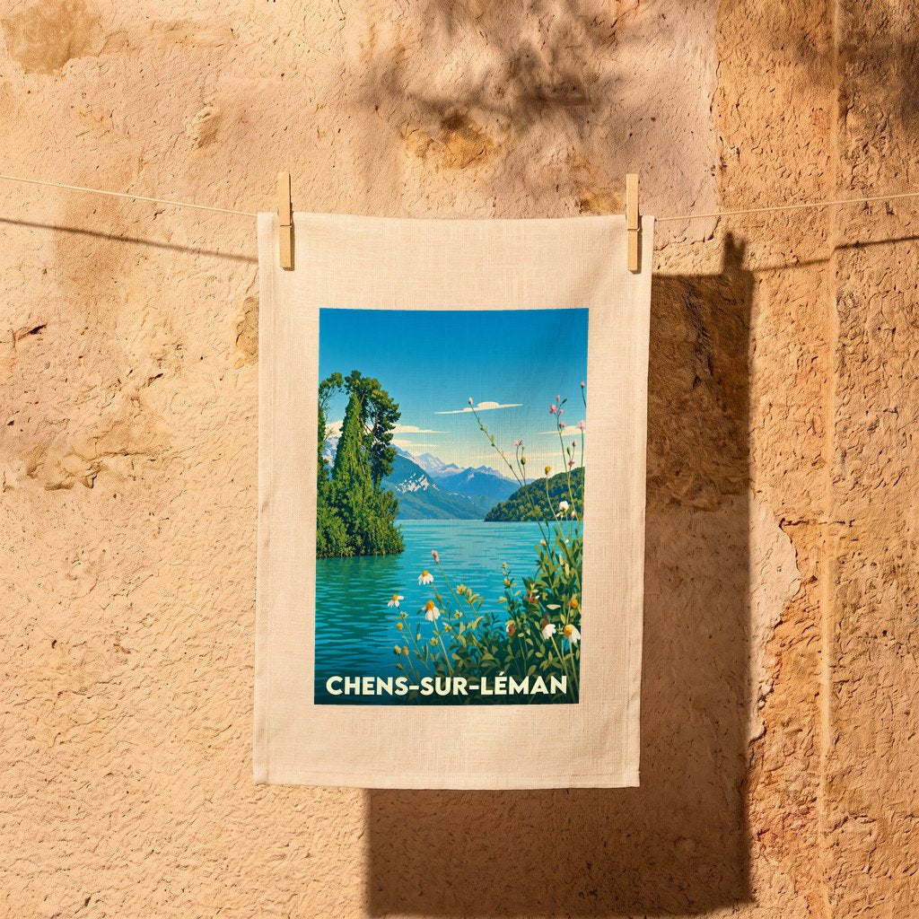 Torchon souvenir de Chens-sur-Léman illustré par un paysage lacustre stylisé et suspendu devant un mur en pierre.