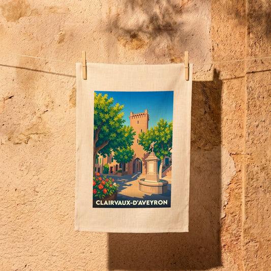 Torchon souvenir de la ville de Clairvaux-d'Aveyron orné d'une illustration stylisée de son centre historique.