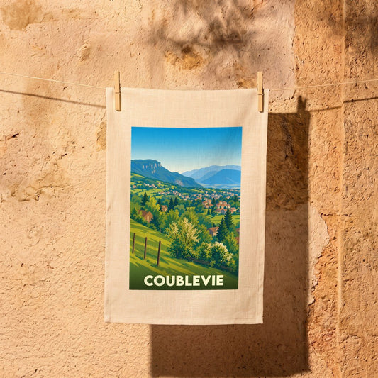Torchon souvenir de la ville de Coublevie avec une illustration paysagère stylisée.