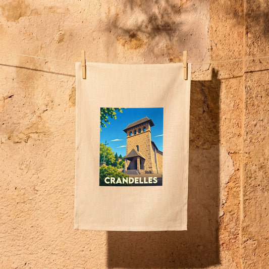 Torchon souvenir de la ville de Crandelles avec une illustration stylisée de son église.