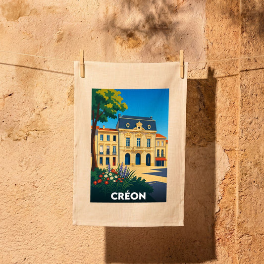 Torchon souvenir de la ville de Créon avec une illustration colorée et stylisée de son architecture.