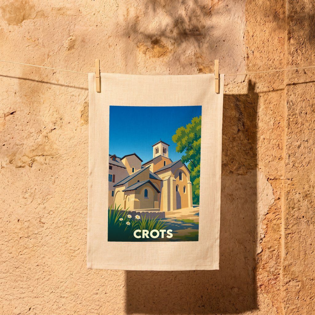 Torchon souvenir de la ville de Crots avec une illustration stylisée de son église romane.