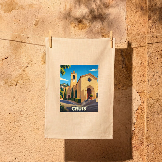 Torchon souvenir de la ville de Cruis avec une illustration stylisée de son église.