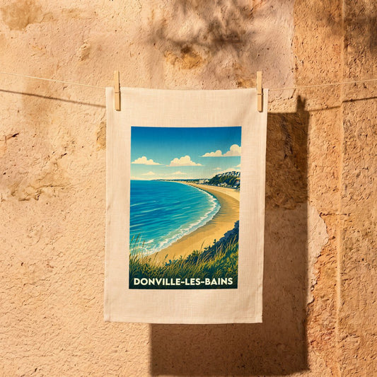 Torchon souvenir de la ville de Donville-les-Bains avec une illustration stylisée de sa plage.