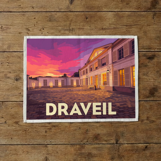 Torchon souvenir de la ville de Draveil avec une illustration stylisée d'un bâtiment au coucher du soleil.