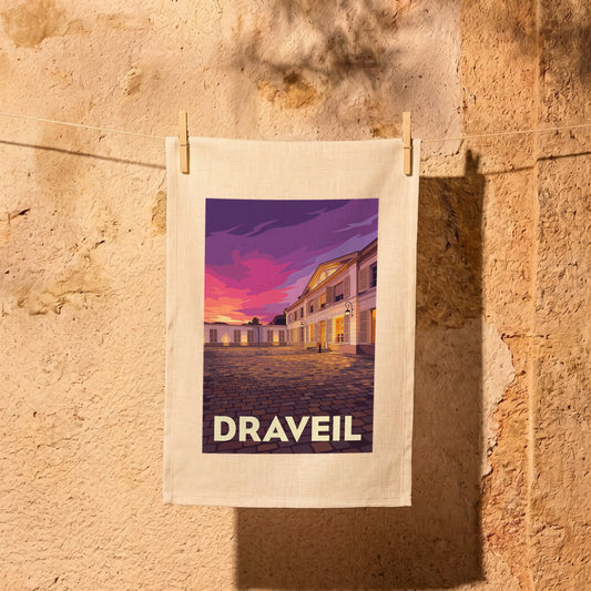 Torchon souvenir de la ville de Draveil avec une illustration stylisée d'un bâtiment au coucher du soleil.