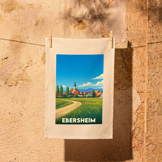 Torchon souvenir de la ville d'Ebersheim avec une illustration stylisée représentant un paysage champêtre et son clocher.