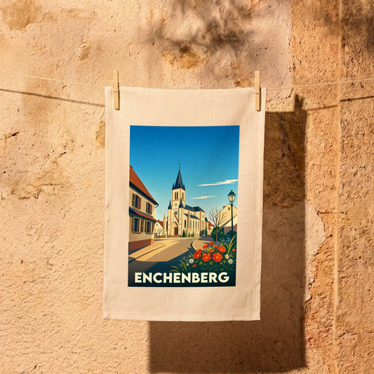 Torchon souvenir de la ville d'Enchenberg avec une illustration stylisée d'une église et de maisons typiques.