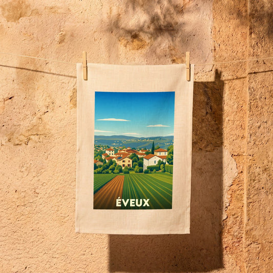Torchon souvenir de la ville d'Éveux orné d'une illustration stylisée de son paysage rural.