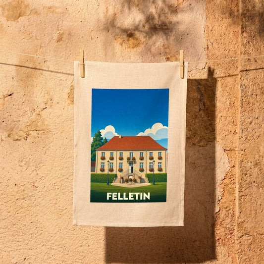 Torchon souvenir de la ville de Felletin avec une illustration stylisée d'un bâtiment fleuri.