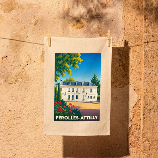 Torchon souvenir de la ville de Férolles-Attilly avec une illustration stylisée de son hôtel de ville.