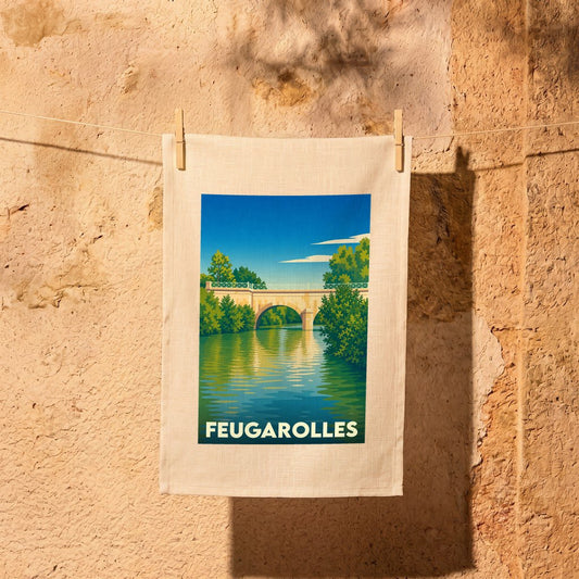 Torchon souvenir de la ville de Feugarolles illustré d'un pont enjambant une rivière dans un style vintage.