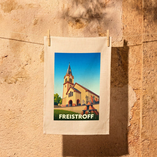 Torchon souvenir de la ville de Freistroff avec une illustration stylisée de son église.