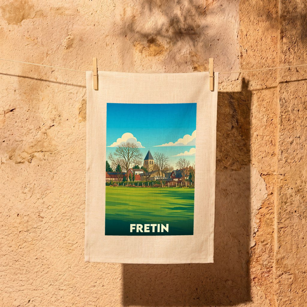 Torchon souvenir de la ville de Fretin illustré d'un paysage champêtre au style rétro.