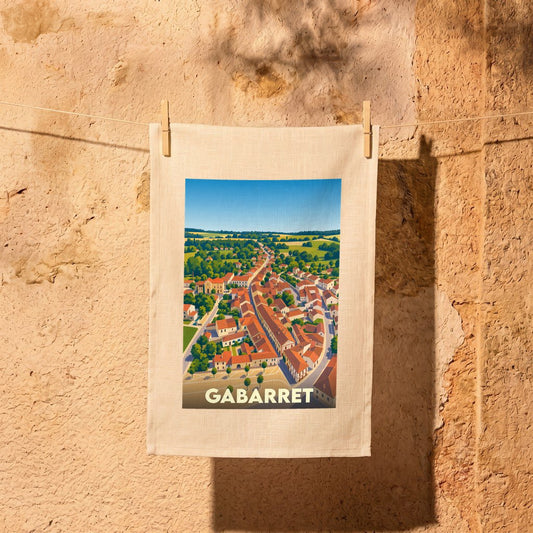 Torchon souvenir de la ville de Gabarret orné d'une illustration stylisée de ses toits orangés.