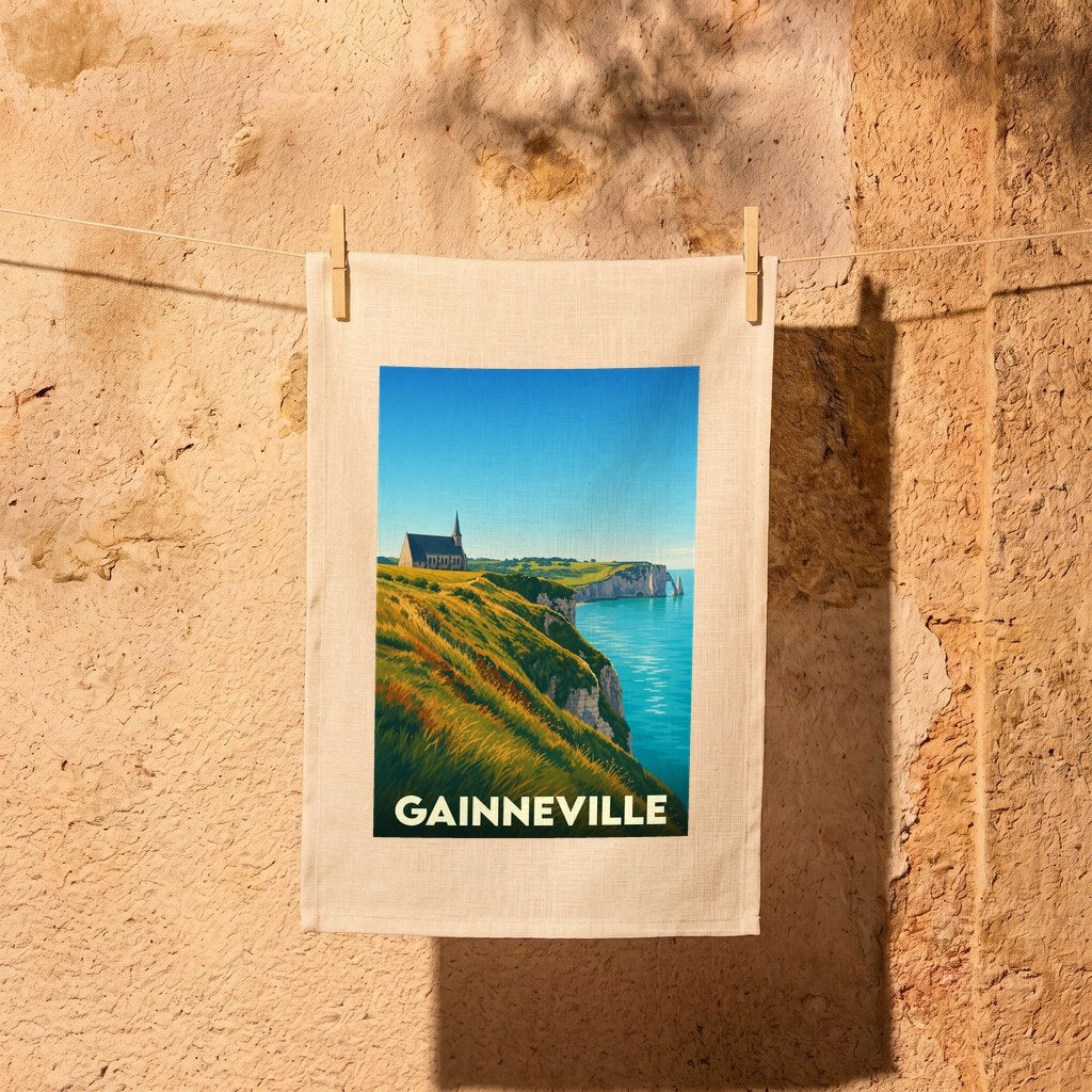Torchon souvenir de la ville de Gainneville avec une illustration stylisée des falaises d'Étretat.