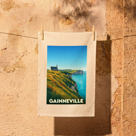 Torchon souvenir de la ville de Gainneville avec une illustration stylisée des falaises d'Étretat.