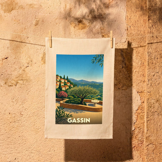 Torchon souvenir de la ville de Gassin avec une illustration stylisée d'un paysage provençal.